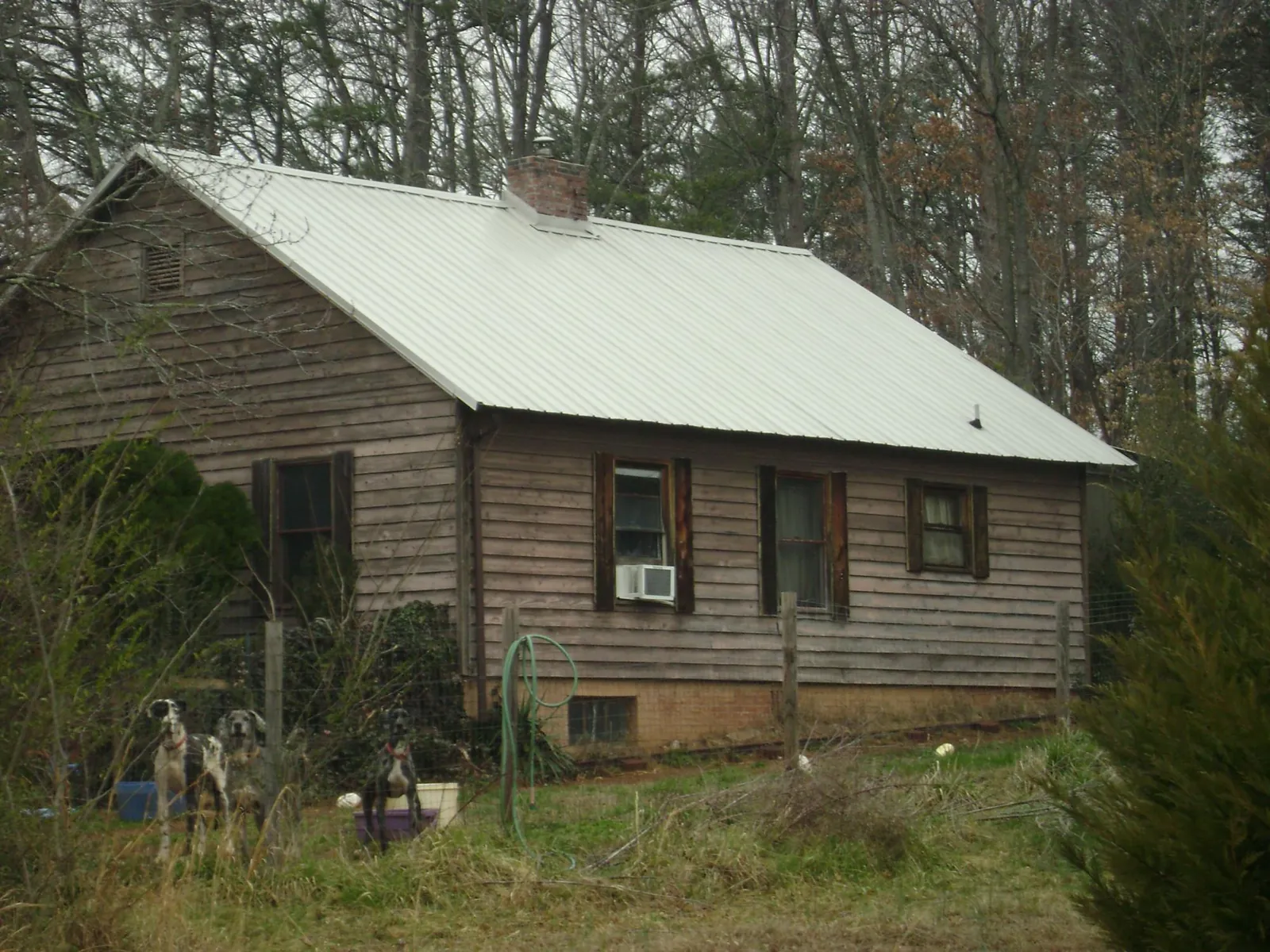 White metal roof on an old wood sided farmhouse, from a Metal Roof Installation job in Hebron